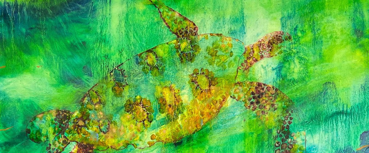 Gold turtle swimming across bright green water